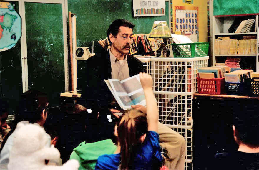 Photo of N. Barry reading to children