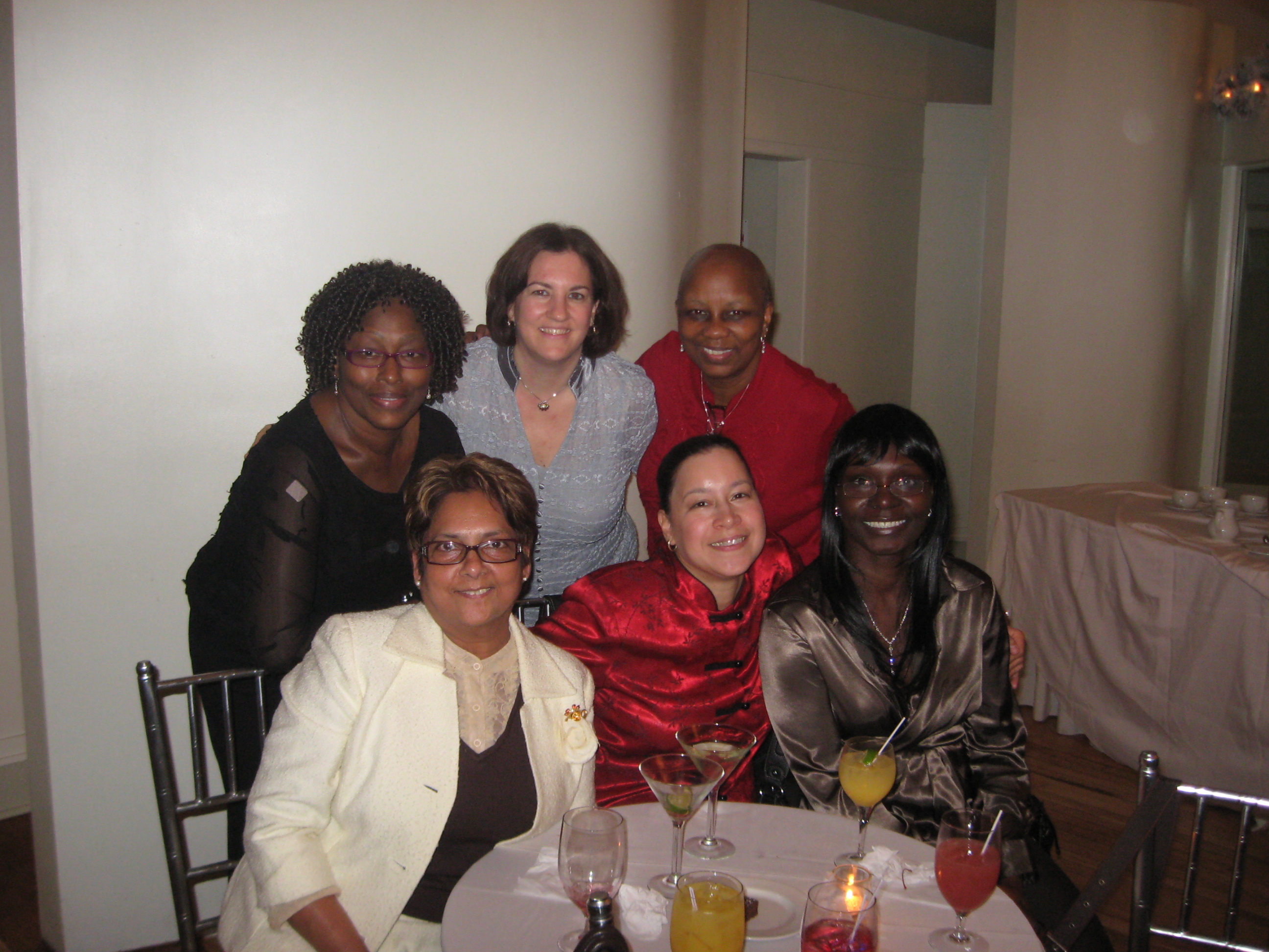 In the Holiday Spirit: top row (l. to r.) Mary Paul Desuza, Debbie Briffa, Verna Fulton; bottom row: Susheila Elahie, Carmen Rios, Michele Bostic 